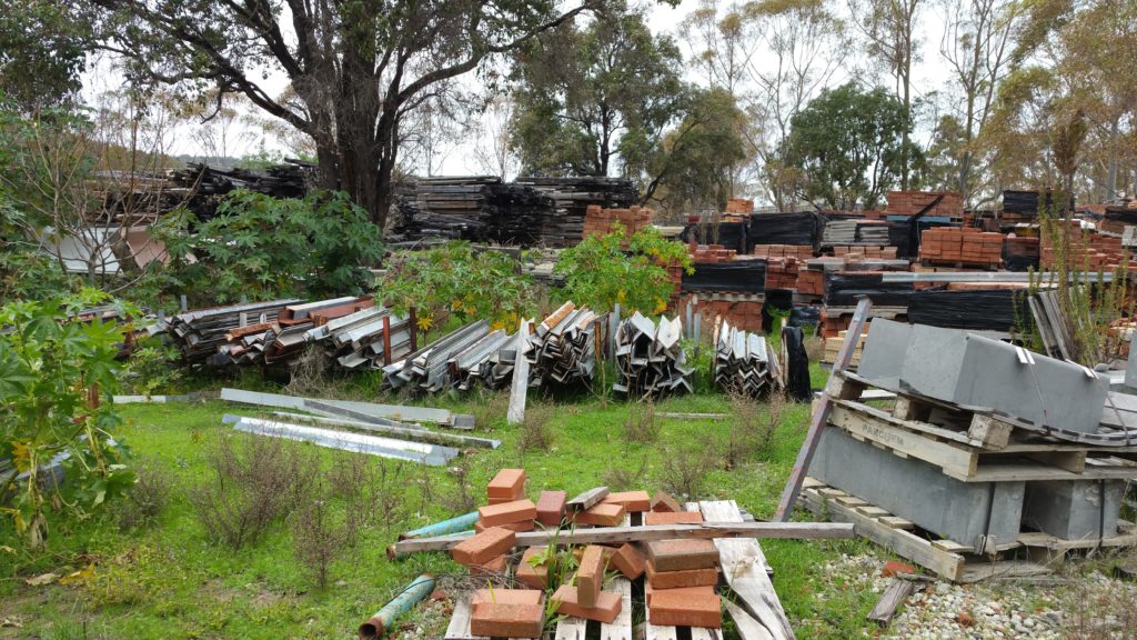 Brajkovich Salvage Yard with materials on the grass ground